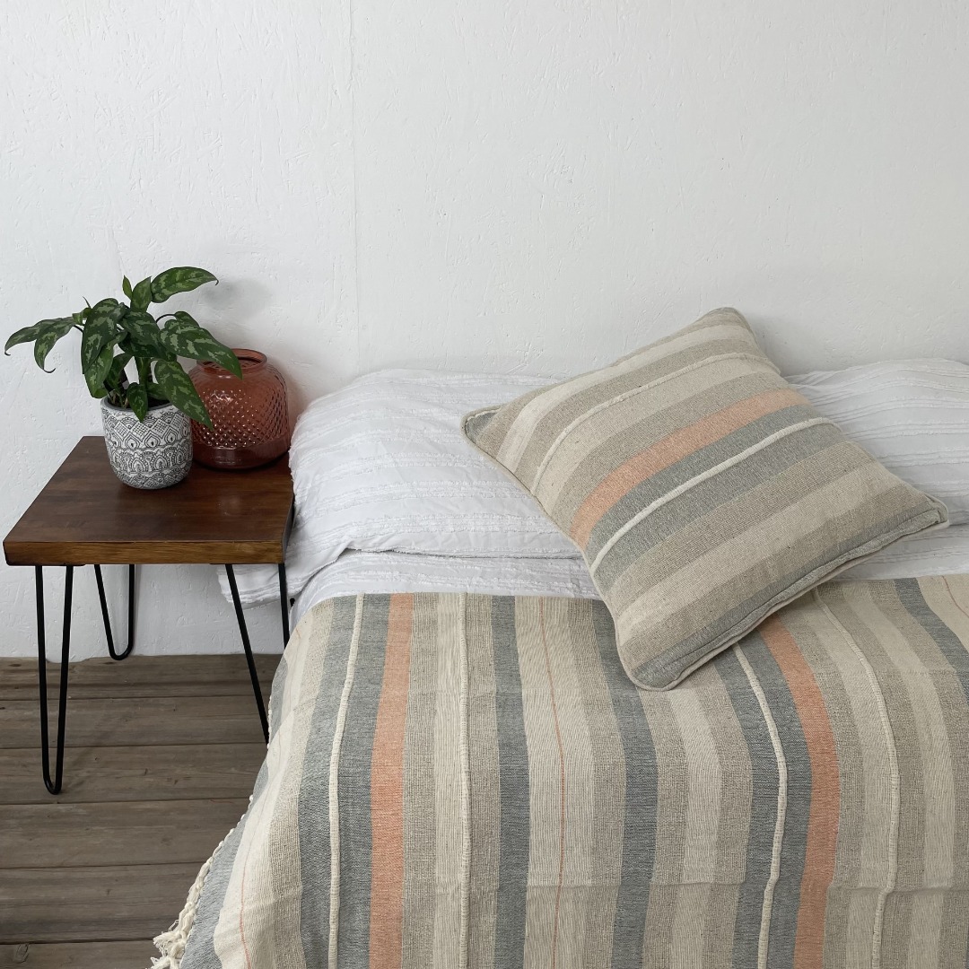 Rustic style striped cushion with a dreamy colour palette of peach, soft blues and neutrals.