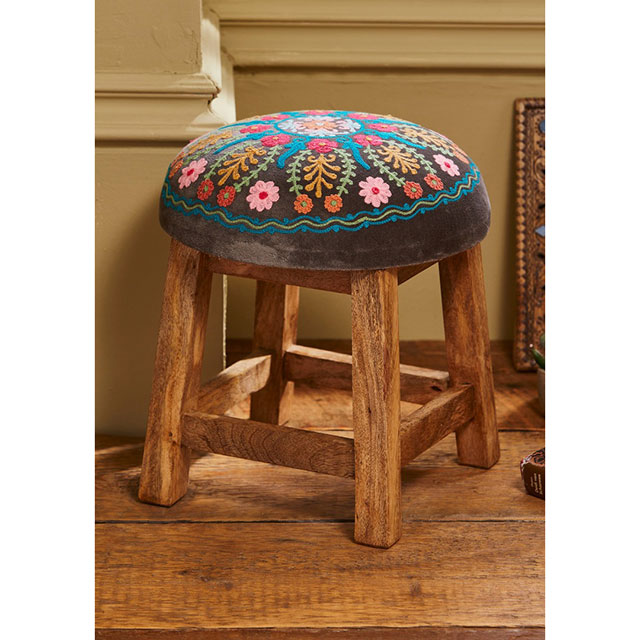 Small stool made with a with wooden frame and soft grey velvet embroidered seat cushion