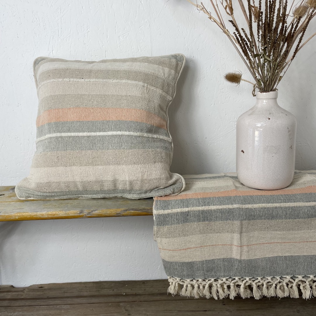 Rustic style striped cushion with a dreamy colour palette of peach, soft blues and neutrals.